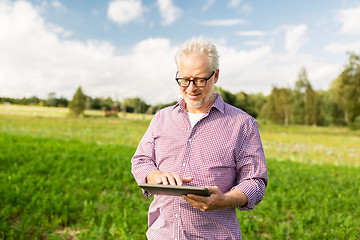 Image showing senior man with tablet pc computer at county