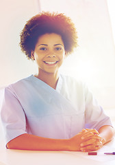 Image showing happy doctor or nurse with clipboard at hospital