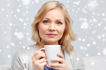 Image showing woman with cup of tea or coffee at home