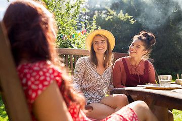 Image showing happy friends having dinner at summer garden