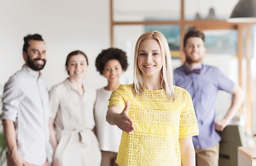 Image showing woman making handshake over creative office team