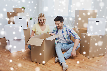 Image showing smiling couple with big boxes moving to new home