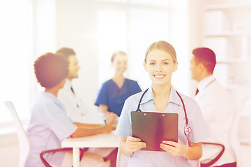 Image showing happy doctor over group of medics at hospital