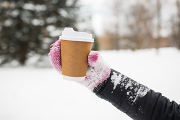 Image showing close up of hand with coffee outdoors in winter