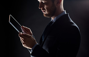 Image showing close up of businessman with transparent tablet pc