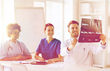 Image showing group of happy doctors discussing x-ray image