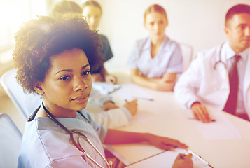 Image showing female doctor over group of medics at hospital