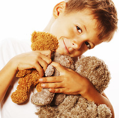 Image showing little cute boy with many teddy bears hugging isolated close up