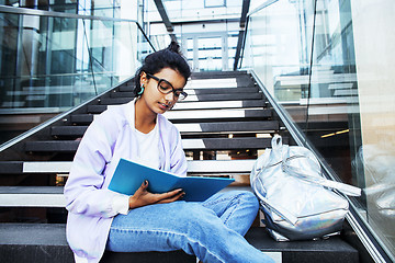 Image showing young cute indian girl at university building sitting on stairs 