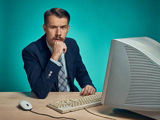 Image showing Surprised Young Man Working On computer At Desk