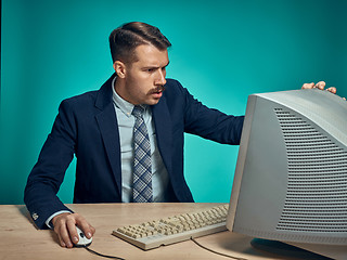 Image showing Surprised Young Man Working On computer At Desk