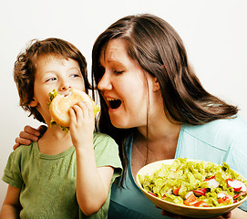 Image showing fat woman holding salad and little cute boy with hamburger teasing