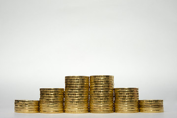 Image showing Six stacks of coins increasing height symmetrically on a white background, pockmarked stands on the edge of the Russian 10 ruble coin