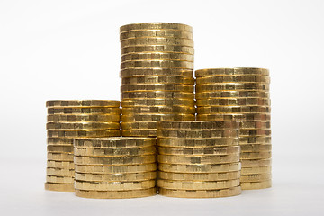 Image showing Five stacks of coins of different height on a white background