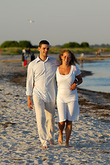 Image showing Young couple walking on beach