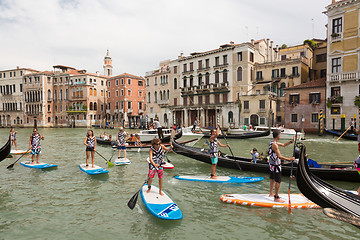 Image showing Group of active tourists stand up paddling on sup boards at Grand Canal, Venice, Italy.