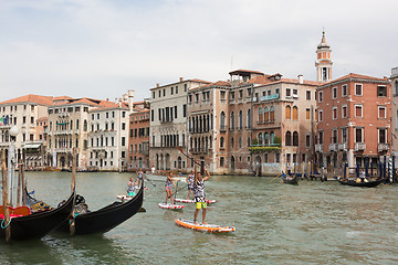 Image showing Group of active tourists stand up paddling on sup boards at Grand Canal, Venice, Italy.