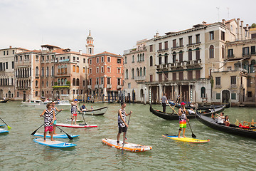 Image showing Group of active tourists stand up paddling on sup boards at Grand Canal, Venice, Italy.