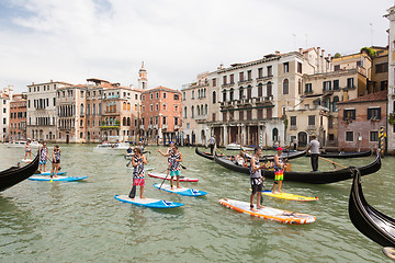 Image showing Group of active tourists stand up paddling on sup boards at Grand Canal, Venice, Italy.