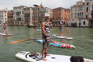 Image showing Group of active tourists stand up paddling on sup boards at Grand Canal, Venice, Italy.