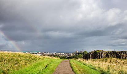 Image showing cloudy sky and rainbow above the city