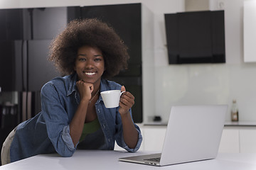 Image showing smiling black woman in modern kitchen