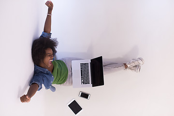 Image showing african american woman sitting on floor with laptop top view