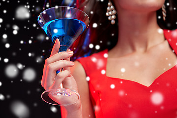 Image showing close up of beautiful woman with cocktail at night