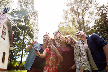 Image showing friends taking selfie at party in summer garden