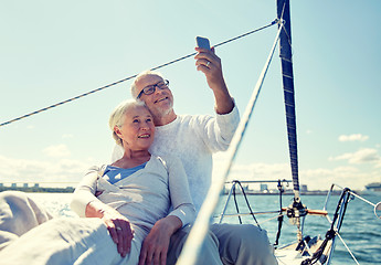 Image showing senior couple taking selfie by smartphone on yacht