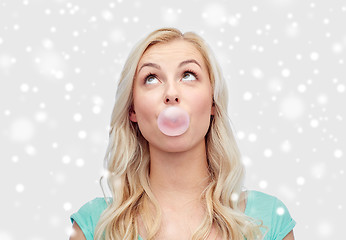 Image showing happy young woman or teenage girl chewing gum