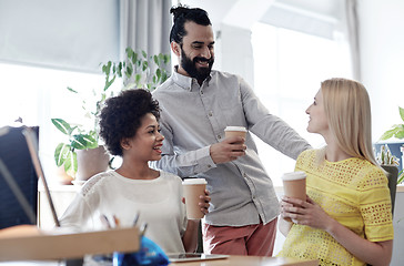 Image showing happy creative team drinking coffee in office