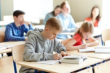 Image showing group of students with books writing school test