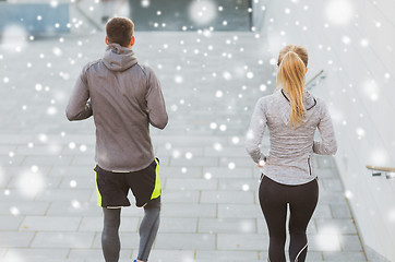 Image showing couple of sportsmen running downstairs outdoors