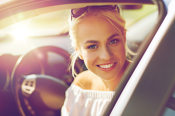 Image showing happy teenage girl or young woman in car