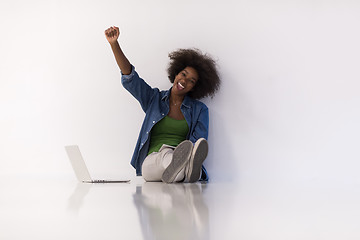 Image showing african american woman sitting on floor with laptop