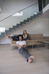 Image showing Young couple on the sofa watching television