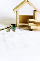 Image showing blueprints and wooden model of house