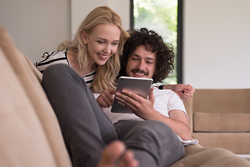 Image showing couple relaxing at  home with tablet computers