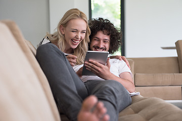 Image showing couple relaxing at  home with tablet computers