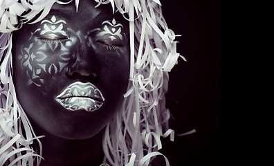 Image showing creative make up like Ethiopian mask, white pattern on black face close up