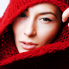 Image showing young pretty woman in sweater and scarf all over her face