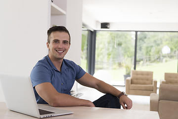 Image showing Young man with laptop at home