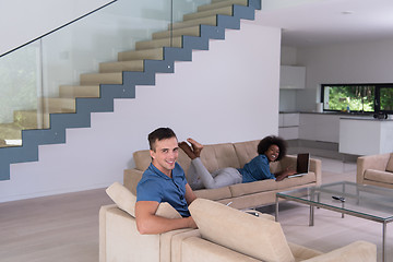 Image showing young multiethnic couple relaxes in the living room