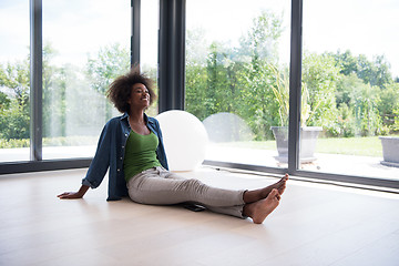 Image showing african american  woman  sitting near window