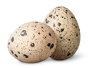 Image showing Two quail eggs beside