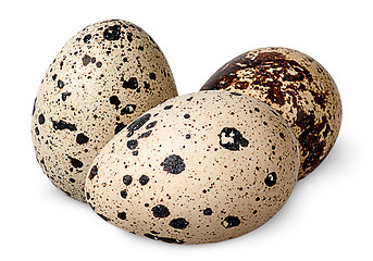 Image showing Three quail eggs beside