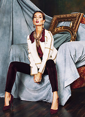 Image showing beauty rich brunette woman in luxury interior near empty frames, vintage elegance