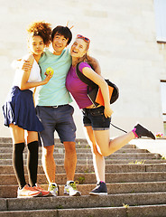 Image showing cute group of teenages at the building of university with books huggings