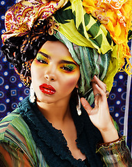 Image showing beauty bright woman with creative make up, many shawls on head like cubian woman